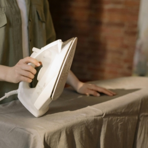 pexels-photo-4107183-4107183 Close-up of a person ironing clothes, showcasing household chores in a home setting.